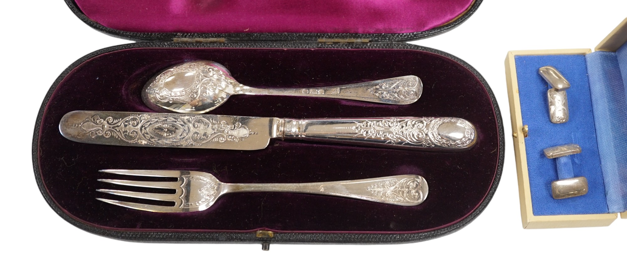 A late Victorian cased chased silver christening trio, London, 1897/90, together with a pair of engraved 925 cufflinks. Condition - fair